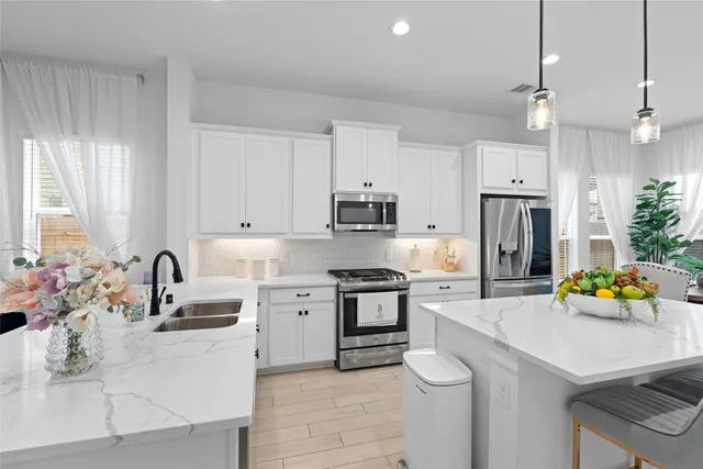 a kitchen with a sink stove and refrigerator
