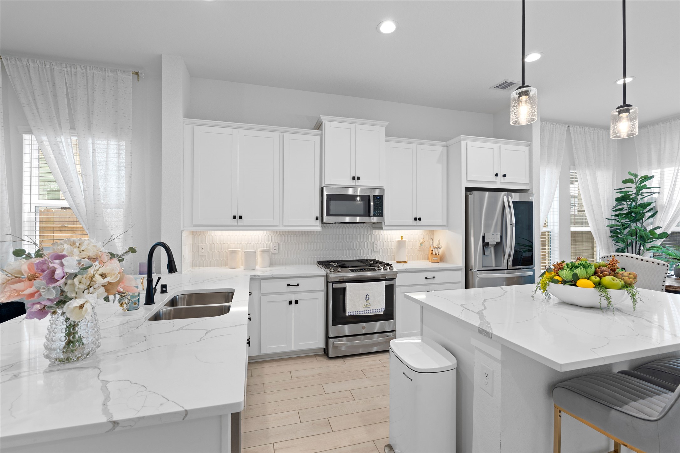 17735 Tree Of Heaven Conroe, TX 77385 - Photo 10 of 35 a kitchen with a sink stove and refrigerator