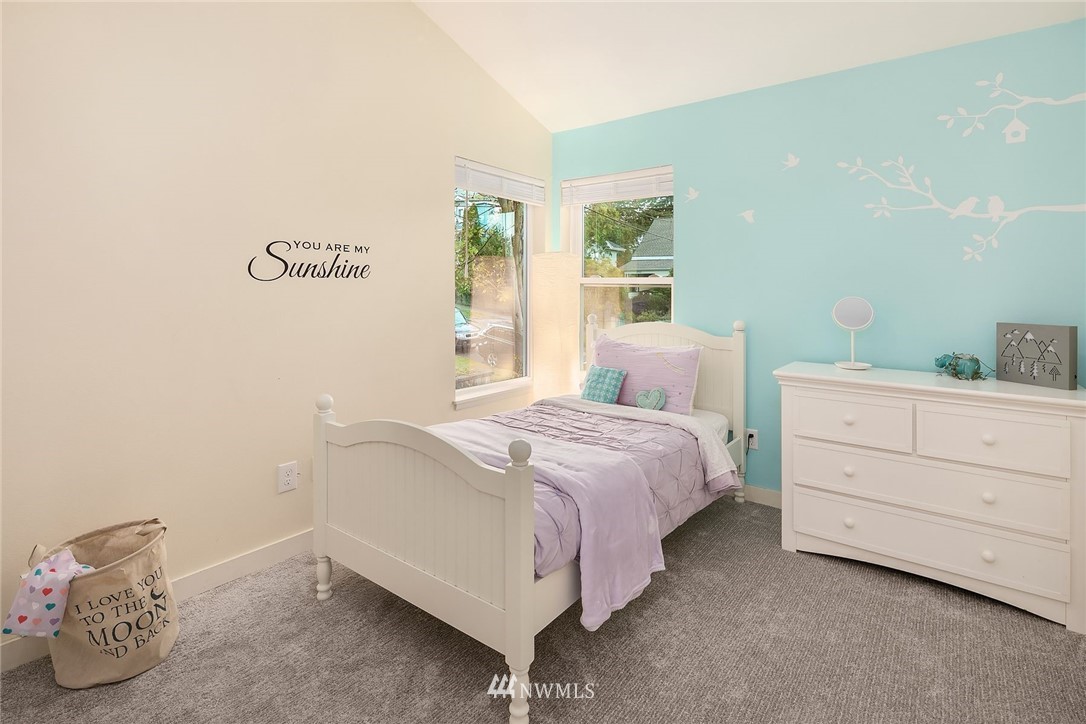 355 North 75th Street Seattle, WA 98103 - Photo 16 of 32 a bedroom with a bed and a window