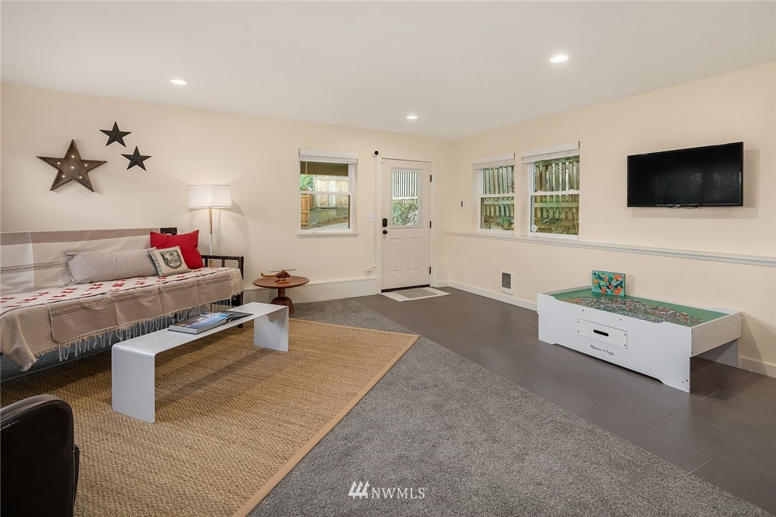 355 North 75th Street Seattle, WA 98103 - Photo 26 of 32 a living room with furniture and a flat screen tv