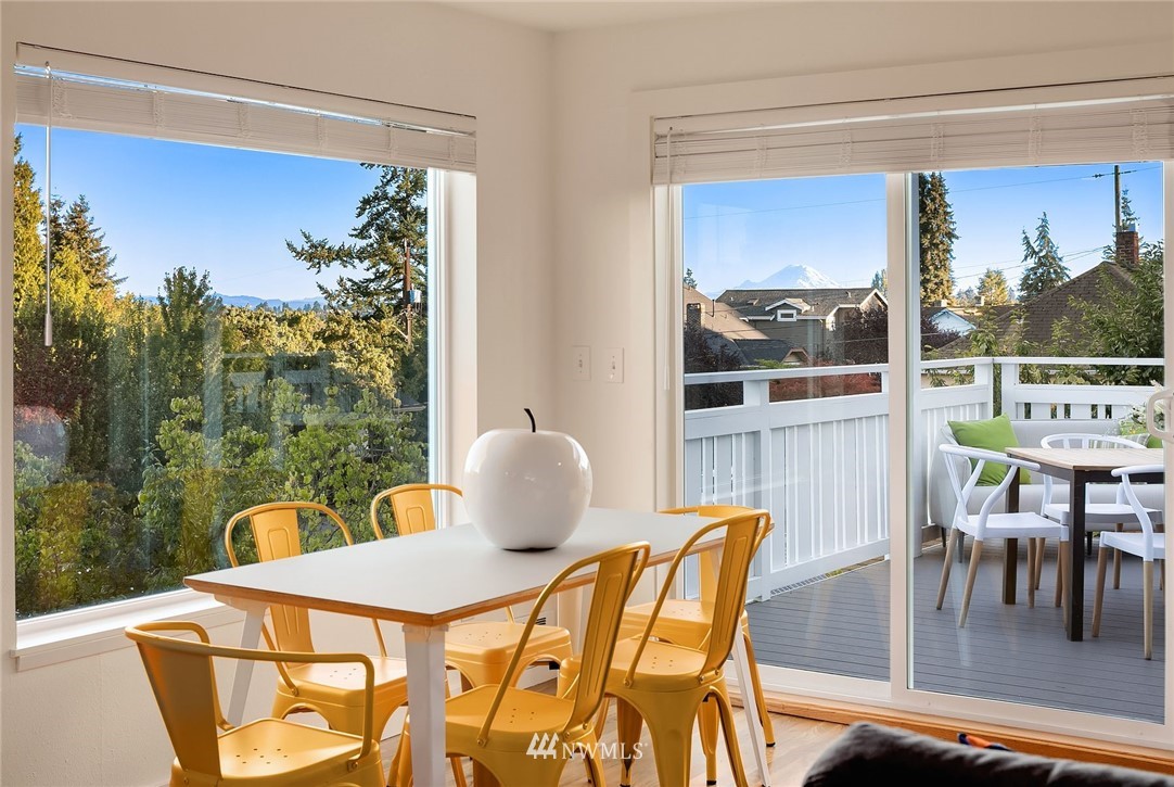 355 North 75th Street Seattle, WA 98103 - Photo 5 of 32 a dining room with furniture and a floor to ceiling window