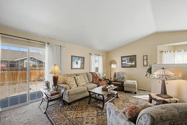 a living room with furniture a large window and a table