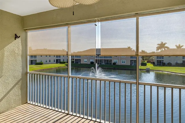 a view of a balcony with floor to ceiling window and wooden floor