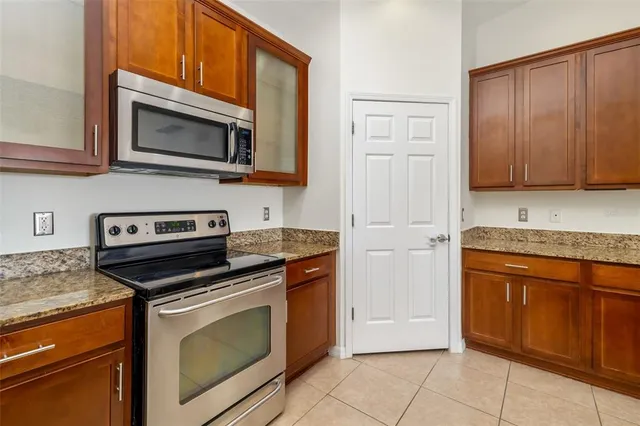 a kitchen with granite countertop cabinets and steel stainless steel appliances