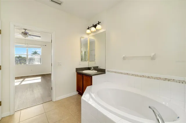 a bathroom with a sink mirror and a bathtub