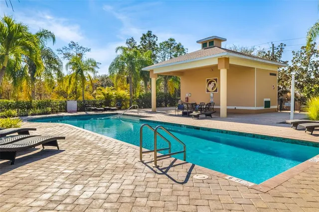 a view of swimming pool with outdoor seating and yard