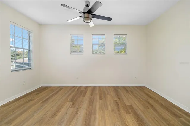 a view of room with hardwood floor and ceiling fan