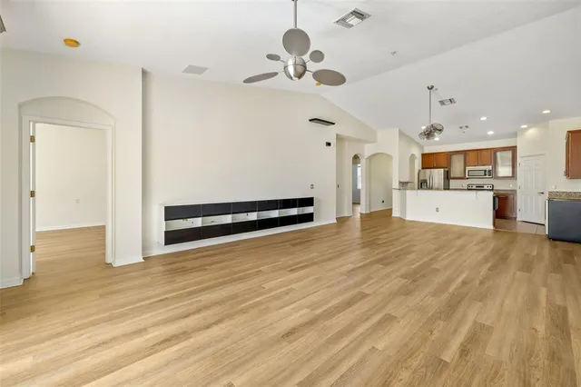 a view of a livingroom with a furniture wooden floor and a ceiling fan