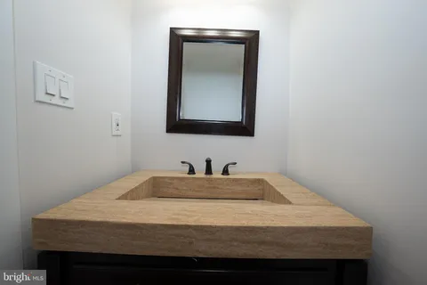 a bathroom with a sink vanity and mirror