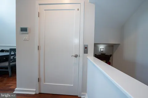 a view of a hallway with wooden floor and closet