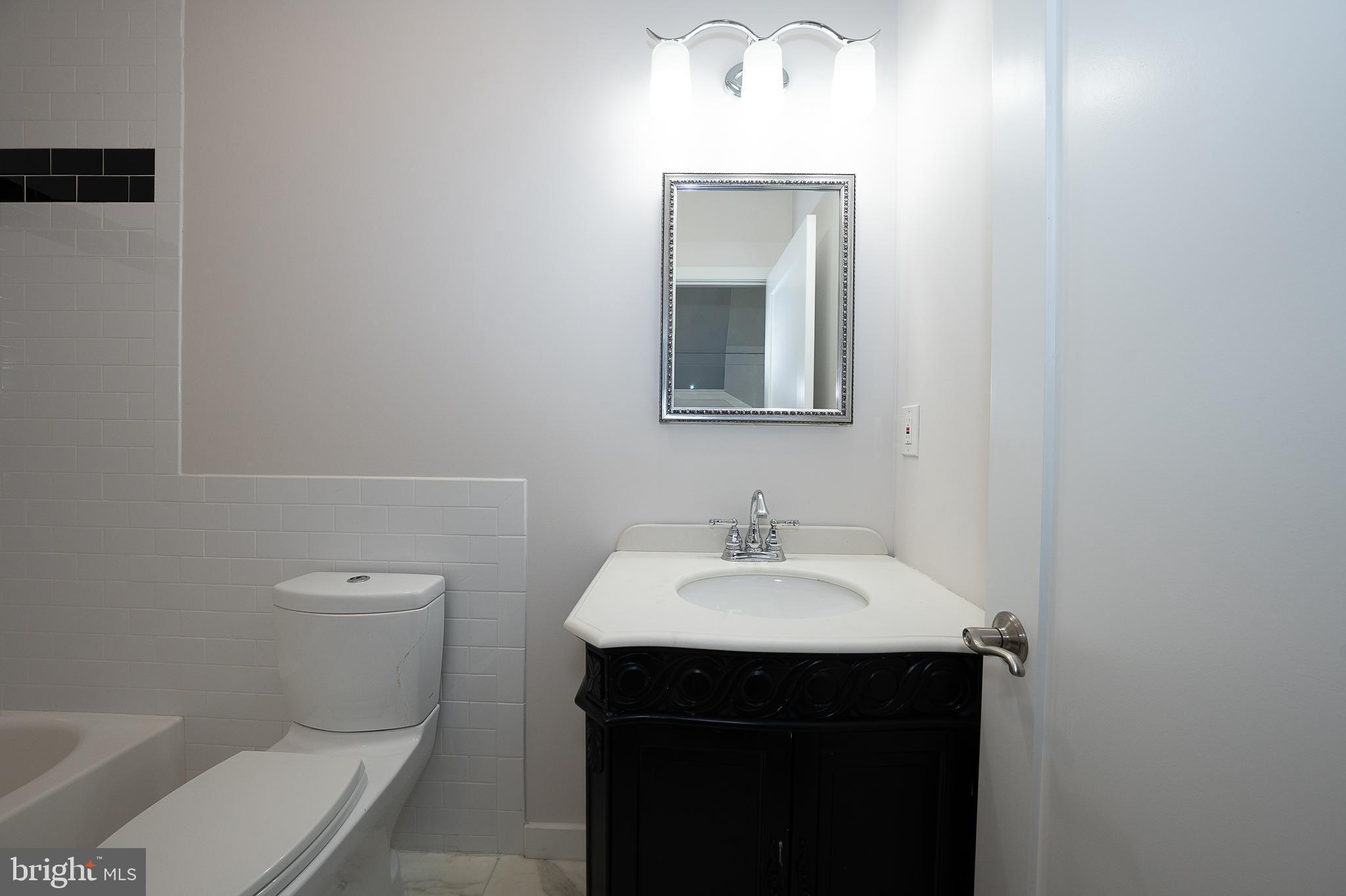 601 Poplar Street Philadelphia, PA 19123 - Photo 19 of 41 a bathroom with a toilet sink and mirror