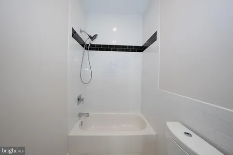 a bathroom with a shower and a toilet