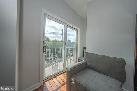 a living room with furniture and a floor to ceiling window