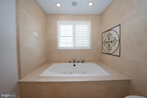a bathroom with a bathtub and a window