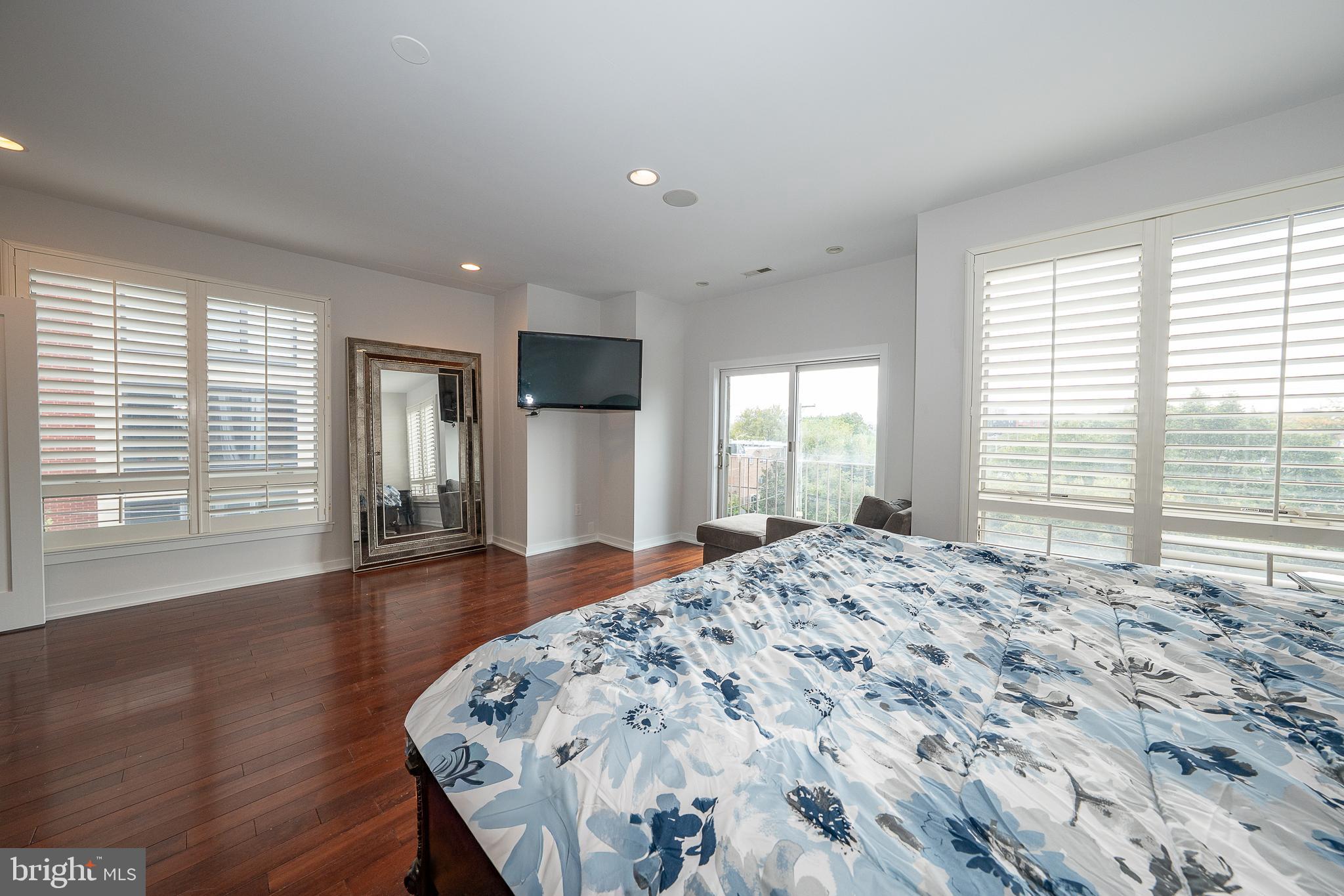 601 Poplar Street Philadelphia, PA 19123 - Photo 33 of 41 a large bedroom with wooden floor and large window