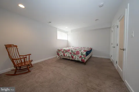 a living room with furniture and a chair