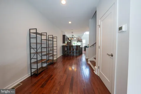 a view of a hallway with wooden floor