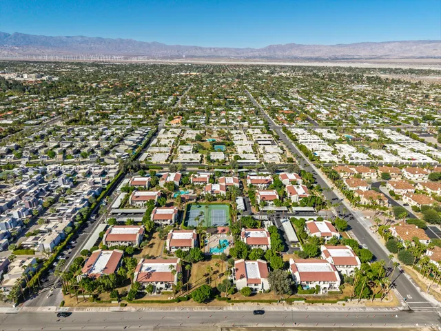 an aerial view of a house with garden space and swimming pool