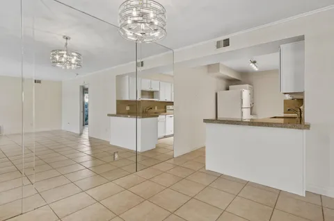 a view of a hallway with chandelier and chandelier