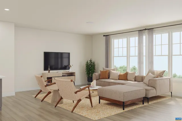 a living room with furniture a flat screen tv and a large window