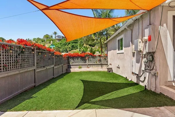 a view of a backyard with sitting area