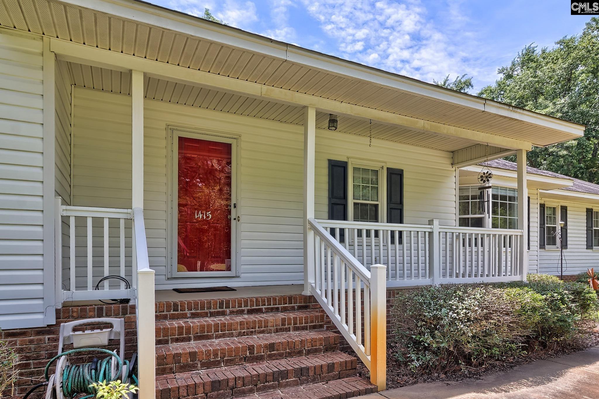 1415 State Rd S-28-55 Lugoff, SC 29078 - Photo 7 of 39 a front view of a house with a porch