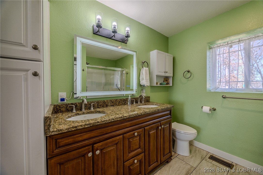 81 Restless Point Camdenton, MO 65020 - Photo 29 of 75 Primary bath with double vanity and lighted led mi