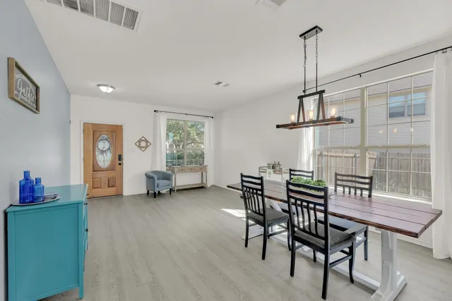 a kitchen with refrigerator cabinets and wooden floor