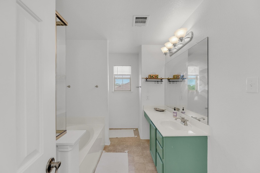 150 Mistletoe Lane Kyle, TX 78640 - Photo 16 of 35 a bathroom with a sink a toilet and shower