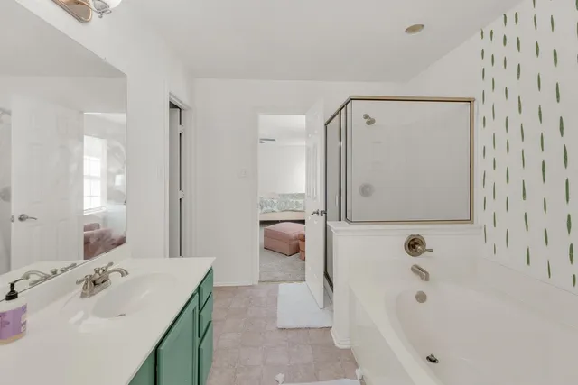 a bathroom with a bathtub and shower