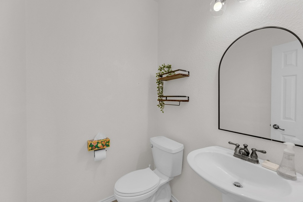 150 Mistletoe Lane Kyle, TX 78640 - Photo 21 of 35 a bathroom with a sink mirror and toilet