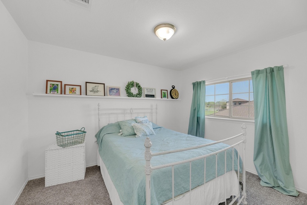 150 Mistletoe Lane Kyle, TX 78640 - Photo 23 of 35 a bedroom with a bed and a dresser