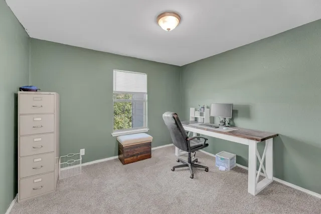 a view of a livingroom with furniture and a window