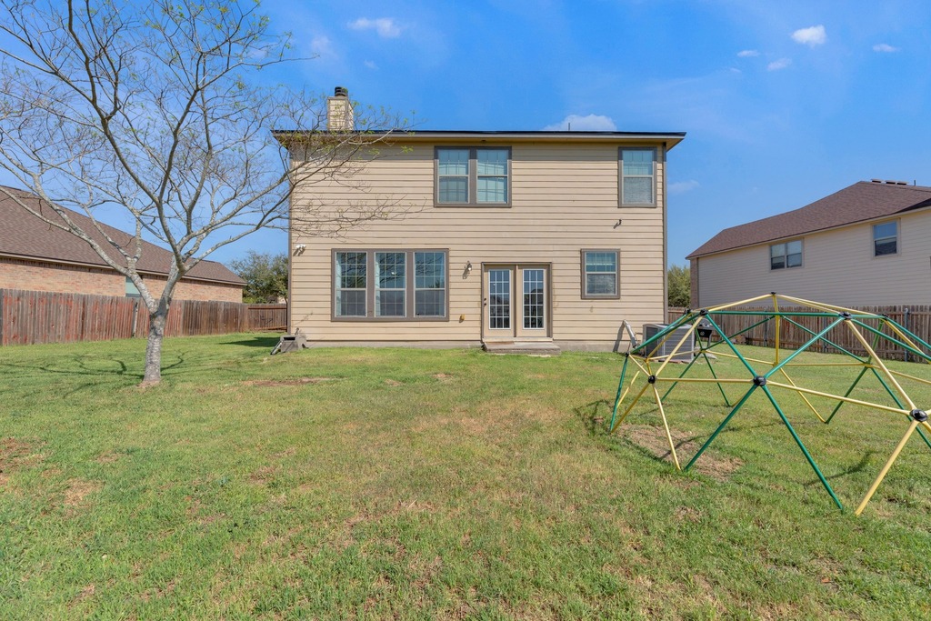 150 Mistletoe Lane Kyle, TX 78640 - Photo 29 of 35 a view of a house with a yard and table and chairs
