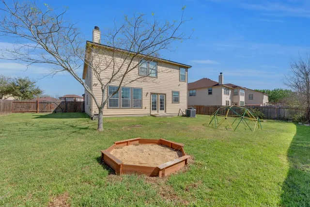 a view of a house with a yard and table and chairs