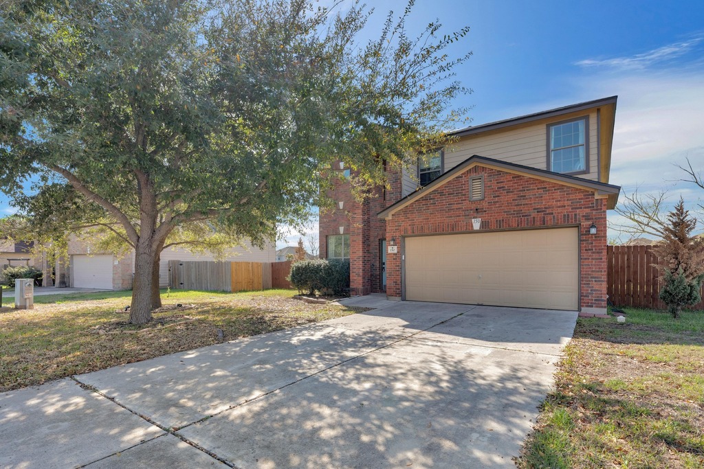 150 Mistletoe Lane Kyle, TX 78640 - Photo 4 of 35 a house with a tree in front of it
