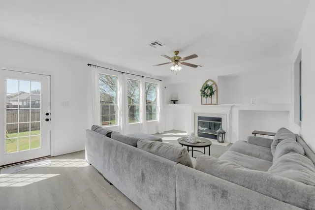 a living room with furniture and a fireplace