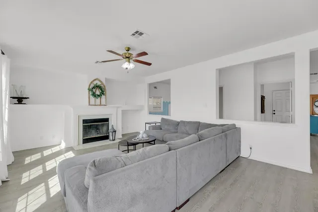 a living room with furniture and a fireplace