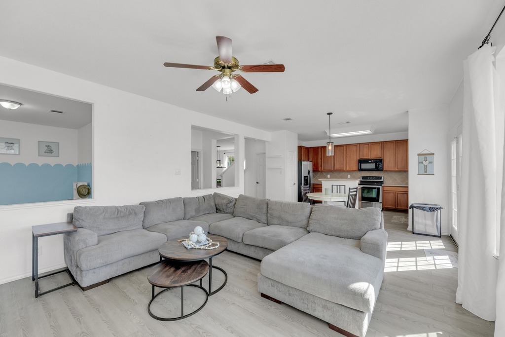 150 Mistletoe Lane Kyle, TX 78640 - Photo 7 of 35 a living room with furniture and a view of kitchen