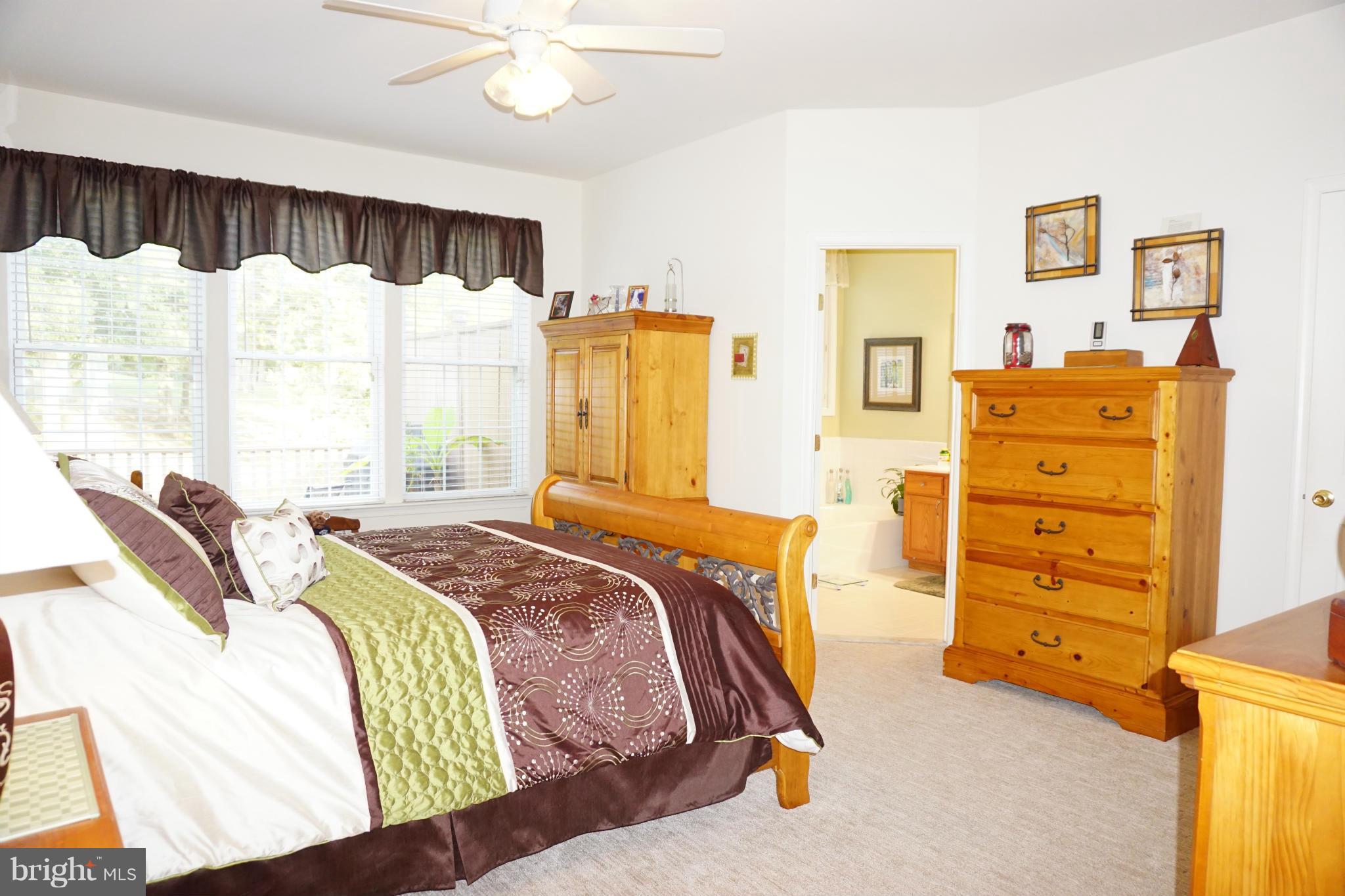 11202 Rawhide Road Lusby, MD 20657 - Photo 8 of 24 a bedroom with a bed and a window