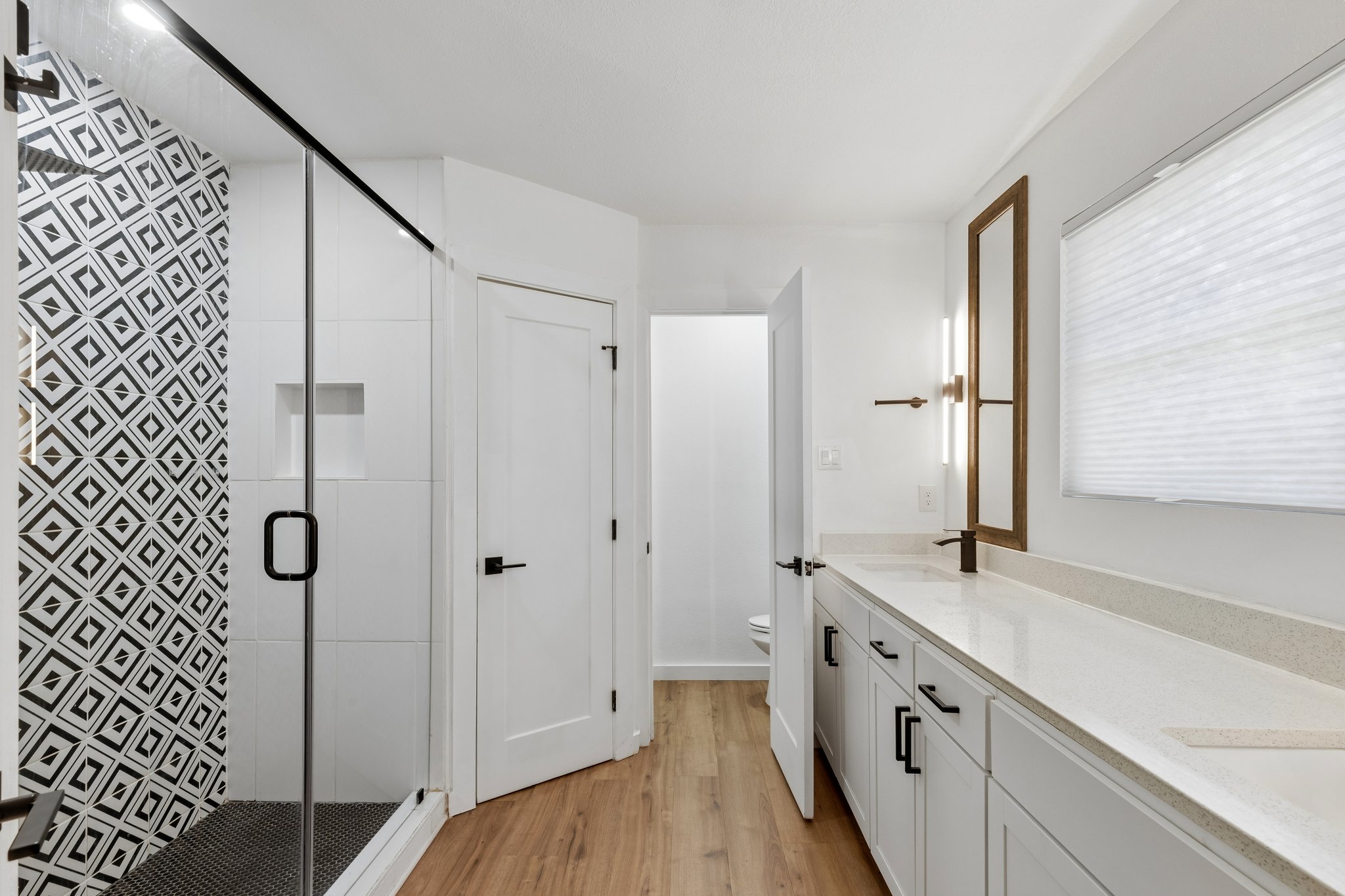 1900 Rampart Circle Austin, TX 78727 - Photo 6 of 12 Clean lines and geometric tile design define this modern bathroom with dual vanities.