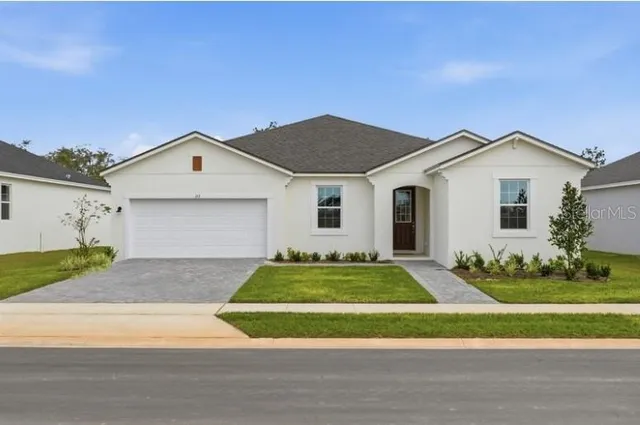 a front view of a house with a yard