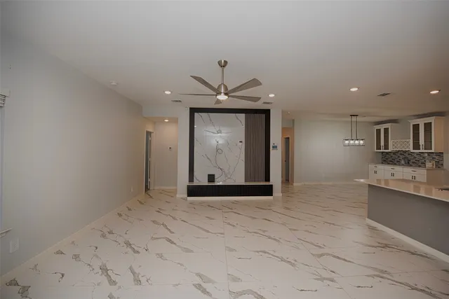 a view of an empty room with a kitchen