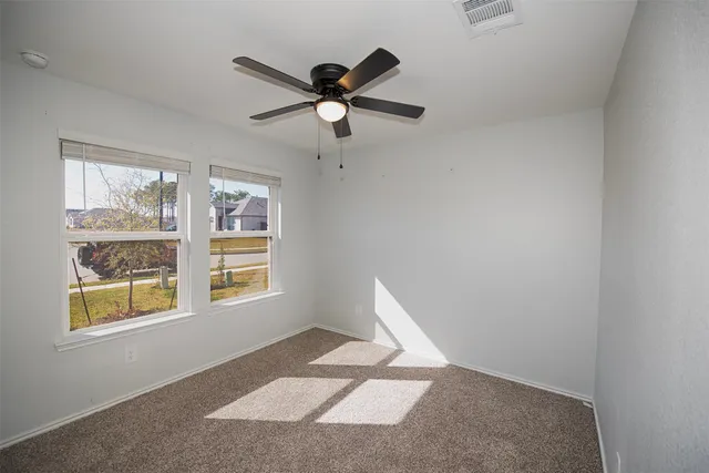 a view of a hallway with a chandelier fan