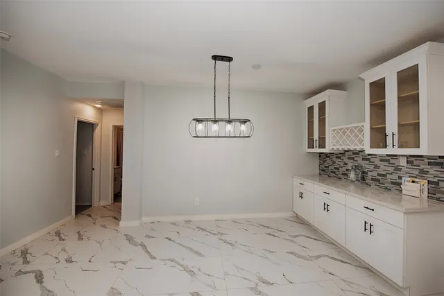 a bathroom with a granite countertop sink a mirror and shower