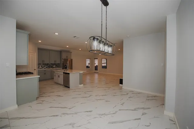 a kitchen with stainless steel appliances granite countertop a sink and cabinets