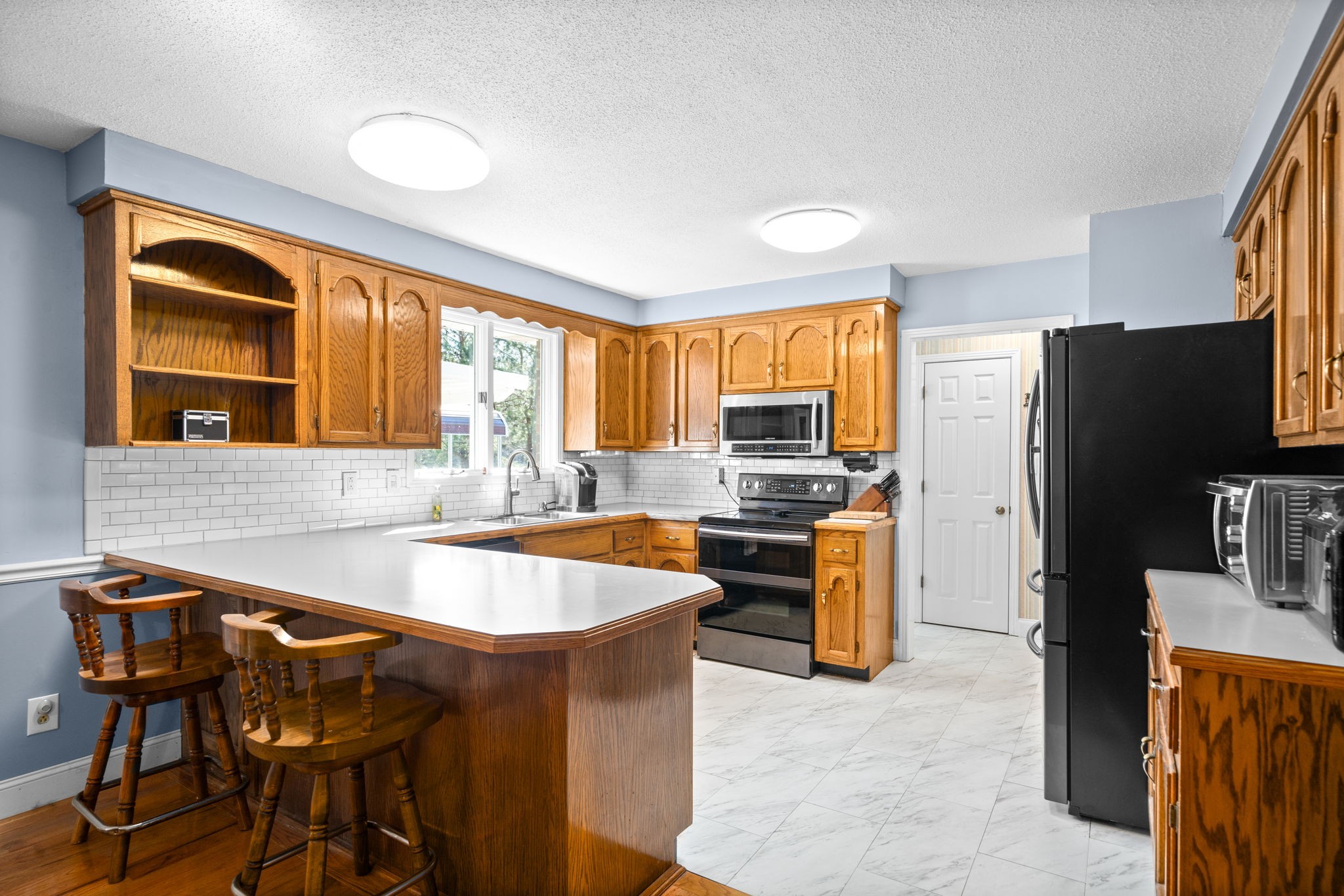 3426 Buck Road Clarksville, TN 37043 - Photo 5 of 57 a kitchen with stainless steel appliances granite countertop a stove refrigerator and microwave