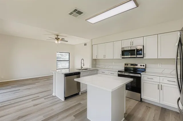 a kitchen with a sink stove and microwave