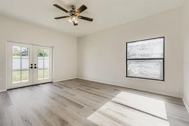 wooden floor in an empty room with a window