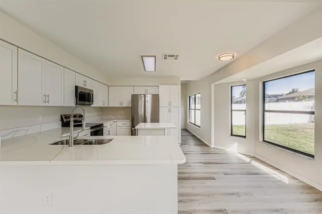 a view of kitchen with furniture and wooden floor
